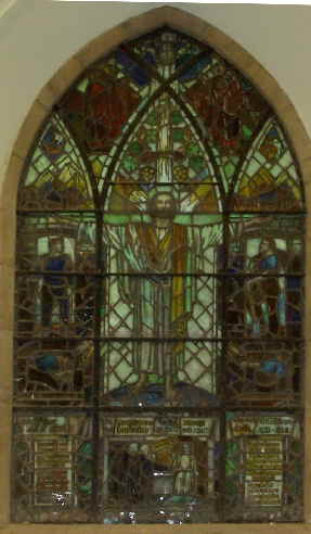 The centre of the window shows the Resurrection, beginning at the foot with the scene of the open tomb on Easter morning; then the risen figure of our Lord standing on the world with outstretched arms, with the shape of the cross behind him; and, above, a group of some of the disciples witnessing the Ascensions.